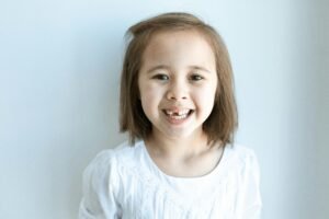 Girl in White Top Smiling