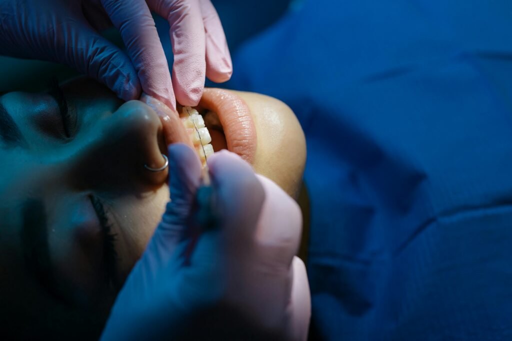 Close-up Photo of Dentist Examining Patient's Teeth