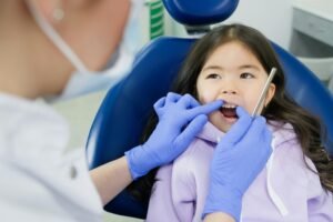 Dentist Checking Teeth of Patient